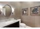 Stylish powder room with modern fixtures, including a sleek vanity and decorative wall art at 8040 Lynch Ln, Indianapolis, IN 46250