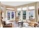 Inviting sunroom with cozy seating arrangement, perfect for relaxation and enjoying natural light at 8040 Lynch Ln, Indianapolis, IN 46250