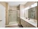 Nicely tiled shower and double sink vanity illuminated by vanity lights for a pleasant atmosphere at 8160 Nik St, Brownsburg, IN 46112
