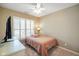 Cozy bedroom with a twin bed, a ceiling fan, and window blinds for natural lighting at 8160 Nik St, Brownsburg, IN 46112