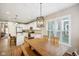 Eat-in kitchen and dining area featuring white cabinets and island seating and a rustic chandelier at 8160 Nik St, Brownsburg, IN 46112