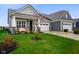 Home featuring well-kept lawn, inviting porch with seating and attached garages at 8160 Nik St, Brownsburg, IN 46112