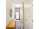 Bright hallway with wood floors, decor, and an open doorway to the outside at 8160 Nik St, Brownsburg, IN 46112