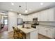 Modern kitchen with stainless steel appliances, island with seating and pendant lighting at 8160 Nik St, Brownsburg, IN 46112