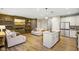 Contemporary living room adjacent to kitchen boasting a fireplace, floating shelves and wood plank accent wall at 8160 Nik St, Brownsburg, IN 46112