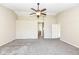A large bedroom features a ceiling fan, neutral tones, and new carpet at 8424 Nuckols Ln, Indianapolis, IN 46237