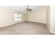 A bedroom features a ceiling fan, high ceilings, and large window at 8424 Nuckols Ln, Indianapolis, IN 46237