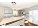 Bright kitchen with gray cabinetry, granite countertops, a wood-topped island, and modern appliances and hardwood floors at 8424 Nuckols Ln, Indianapolis, IN 46237
