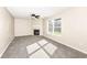Cozy living room with a fireplace, ceiling fan, and lots of natural light at 8424 Nuckols Ln, Indianapolis, IN 46237