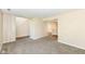 Open living room featuring neutral paint, plush carpet, stairs leading up, and access to kitchen at 8424 Nuckols Ln, Indianapolis, IN 46237