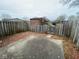 Enclosed backyard with a concrete patio, a wood fence, and foliage at 914 Greenwood E Trl, Greenwood, IN 46142