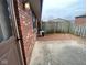 A brick exterior with a small patio, red gravel, and a wooden fence at 914 Greenwood E Trl, Greenwood, IN 46142