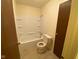 Clean bathroom featuring a shower-tub combo, white fixtures, and tiled flooring for a neat and functional space at 914 Greenwood E Trl, Greenwood, IN 46142
