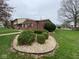 Exterior of a red brick home with landscaping and a healthy lawn at 914 Greenwood E Trl, Greenwood, IN 46142