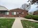 Charming brick townhouse featuring a well-maintained lawn and a cozy, inviting entryway at 914 Greenwood E Trl, Greenwood, IN 46142