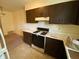 Cozy kitchen features wood cabinets, white countertops and modern appliances including a range and hood at 914 Greenwood E Trl, Greenwood, IN 46142