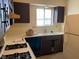 Charming kitchen showcases a window above the sink, white countertops, and an efficient layout with modern appliances at 914 Greenwood E Trl, Greenwood, IN 46142