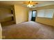 Comfortable living room with ceiling fan, tile entry, and outdoor views, leading into the kitchen area at 914 Greenwood E Trl, Greenwood, IN 46142