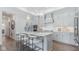 Bright kitchen with a large island, marble countertops, pendant lighting, and modern stainless steel appliances at 9150 Bryce Cir, Zionsville, IN 46077