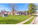 Spacious backyard features a well-maintained lawn, mature trees, and a charming deck for outdoor enjoyment at 923 Jonathan Dr, Plainfield, IN 46168