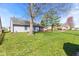 Spacious backyard featuring a well-kept lawn and mature trees at 923 Jonathan Dr, Plainfield, IN 46168