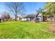 Backyard featuring well-kept lawn, a deck, mature trees, and a fenced in area at 923 Jonathan Dr, Plainfield, IN 46168