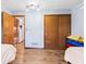 Cozy bedroom featuring wood-look floors, a closet, and colorful toy storage at 923 Jonathan Dr, Plainfield, IN 46168