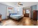 Bedroom featuring hardwood floor, ceiling fan and on-suite bathroom at 923 Jonathan Dr, Plainfield, IN 46168