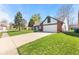 Charming single-story home featuring a well-manicured lawn, two-car garage, and brick accents at 923 Jonathan Dr, Plainfield, IN 46168
