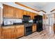 Kitchen with wood cabinets and black appliances at 923 Jonathan Dr, Plainfield, IN 46168