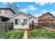 Cozy backyard with a small deck and a grassy area, surrounded by wooden fences and neighboring houses at 947 E Bradbury Ave, Indianapolis, IN 46203