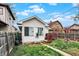 A quaint backyard featuring a small wooden deck and grassy area enclosed by a wooden fence at 947 E Bradbury Ave, Indianapolis, IN 46203