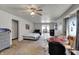 Spacious bedroom with neutral colors and a ceiling fan and fan for added comfort at 947 E Bradbury Ave, Indianapolis, IN 46203