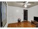 Spare bedroom with hardwood floors, one window, ceiling fan, and an adjacent room at 947 E Bradbury Ave, Indianapolis, IN 46203