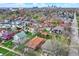 An aerial view of the neighborhood shows proximity to the city and a variety of home styles, all nestled among mature trees at 947 E Bradbury Ave, Indianapolis, IN 46203