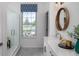 Elegant bathroom featuring a glass-enclosed shower, large vanity, and a window with an view at 998 Kinzer Ave, Carmel, IN 46032