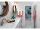 Stylish bathroom with double sink vanity, decorative mirrors, and a closet, offering convenience and ample storage at 998 Kinzer Ave, Carmel, IN 46032