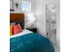 Stylish bedroom featuring a full bed with decorative pillows, black nightstand, and an ensuite bathroom at 998 Kinzer Ave, Carmel, IN 46032