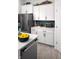 Stylish kitchen with white cabinets, blue backsplash, and stainless steel appliances at 998 Kinzer Ave, Carmel, IN 46032