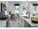 Bright open kitchen featuring stainless steel appliances, quartz countertops, and a stylish faucet at 998 Kinzer Ave, Carmel, IN 46032