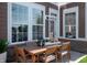 Inviting patio with outdoor dining set, perfect for relaxing or entertaining with ample natural light through large windows at 998 Kinzer Ave, Carmel, IN 46032