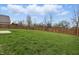 Beautifully maintained backyard with lush green grass and a sturdy wooden fence for privacy at 10016 Jenna Ln, Indianapolis, IN 46239