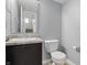 Bathroom features a sink, a toilet and blue colored walls at 10016 Jenna Ln, Indianapolis, IN 46239