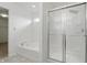 Bright bathroom features a bathtub and a glass-enclosed shower at 10016 Jenna Ln, Indianapolis, IN 46239