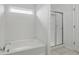 Bathroom features a bathtub and a glass door shower at 10016 Jenna Ln, Indianapolis, IN 46239