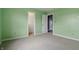 Bedroom featuring light green walls, carpet and access to a walk-in closet at 10016 Jenna Ln, Indianapolis, IN 46239