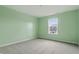 Bedroom featuring light green walls, carpet and window at 10016 Jenna Ln, Indianapolis, IN 46239