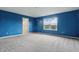 Carpeted bedroom painted in a blue color featuring a window at 10016 Jenna Ln, Indianapolis, IN 46239