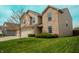 Charming two-story home featuring a blend of brick and siding, complemented by a green lawn at 10016 Jenna Ln, Indianapolis, IN 46239