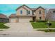 Spacious two-story home with a three-car garage and a well-manicured front lawn at 10016 Jenna Ln, Indianapolis, IN 46239